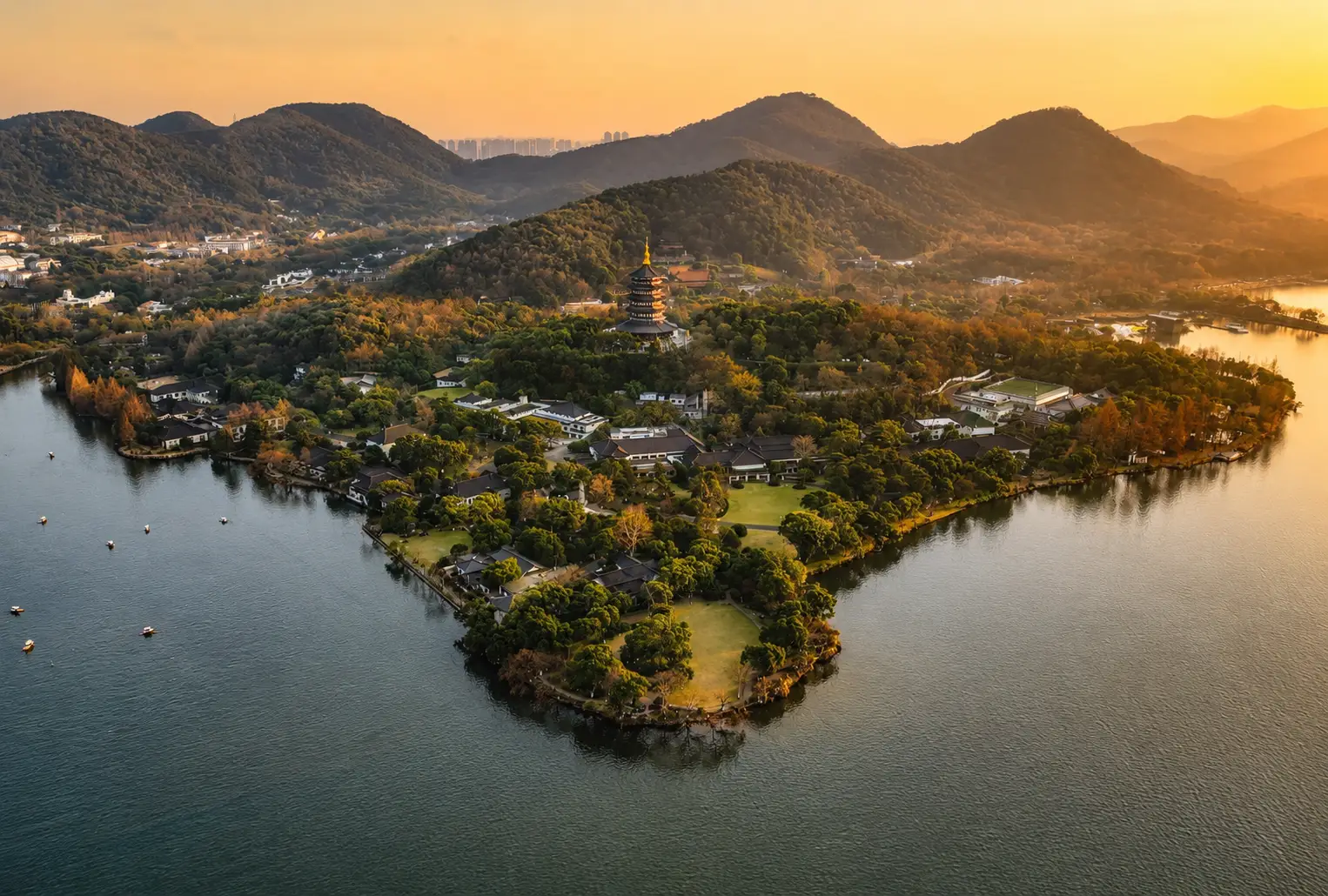 The gardens of Zhejiang Xizi Hotel on West Lake at sunset
